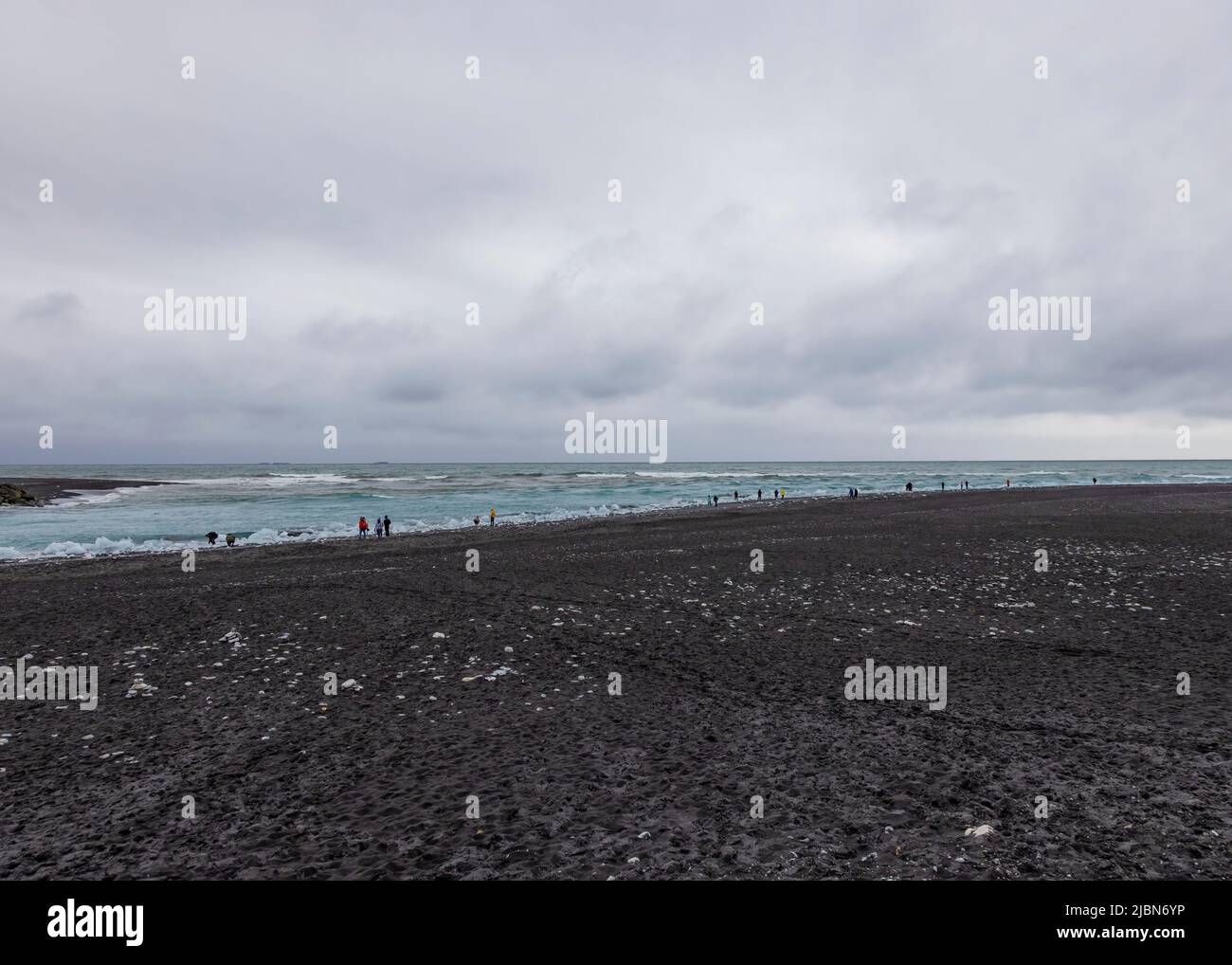 Tourists on Diamond Beach Black sand beach in Iceland Stock Photo
