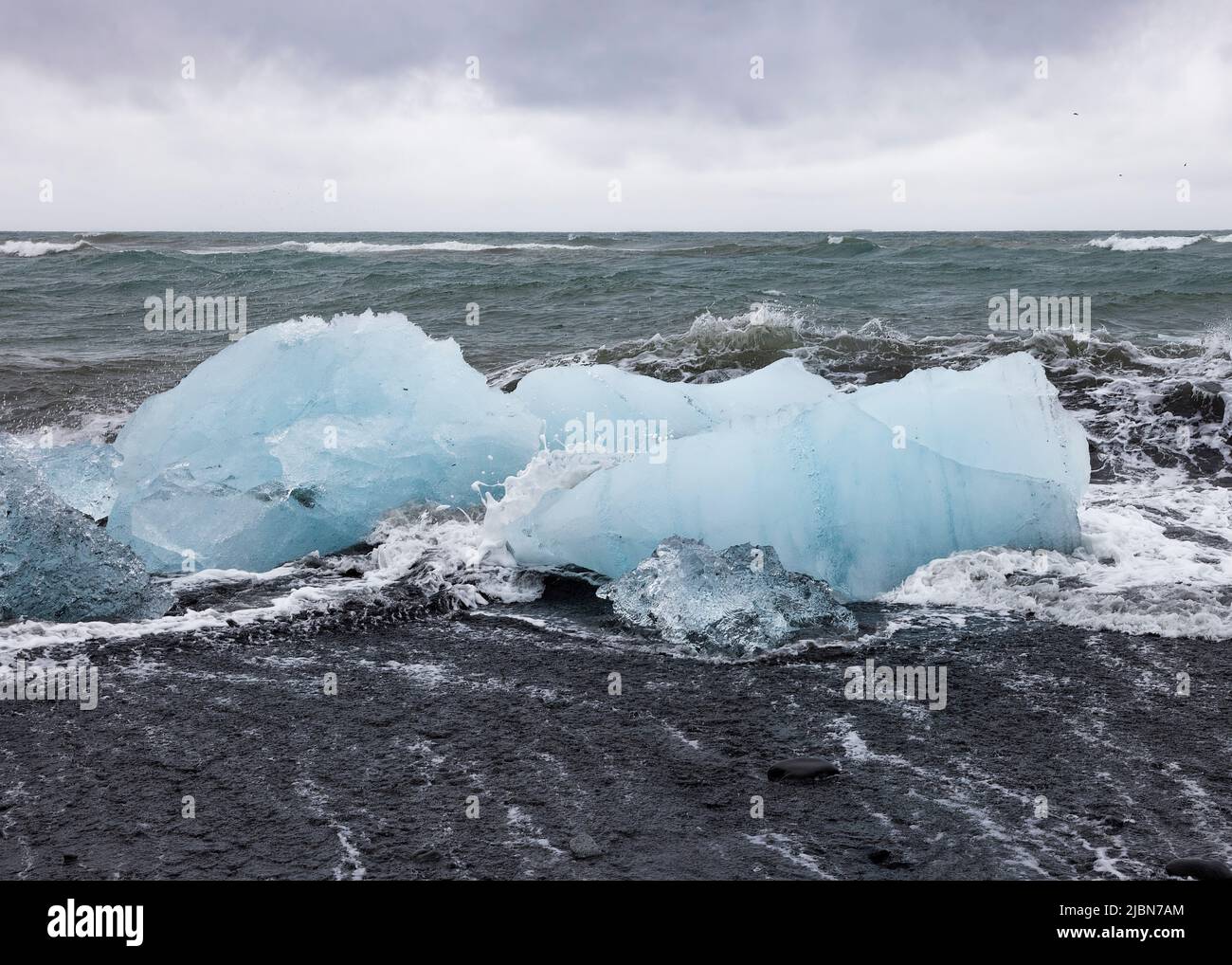 Waves breaking over the ice floes at Diamond Beach Iceland Stock Photo