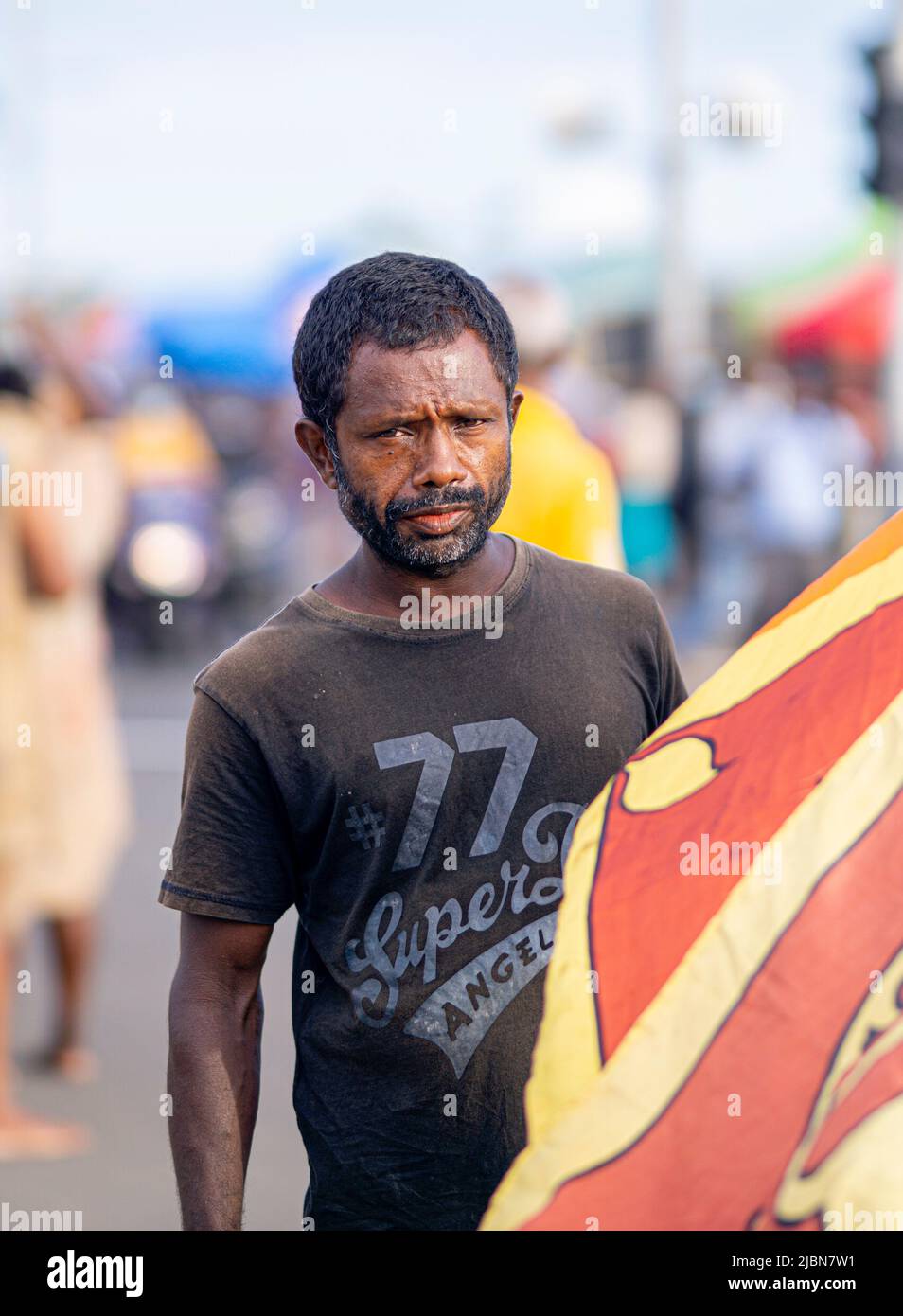 A poor man in Sri Lanka holds the national flag in his hand Stock Photo ...