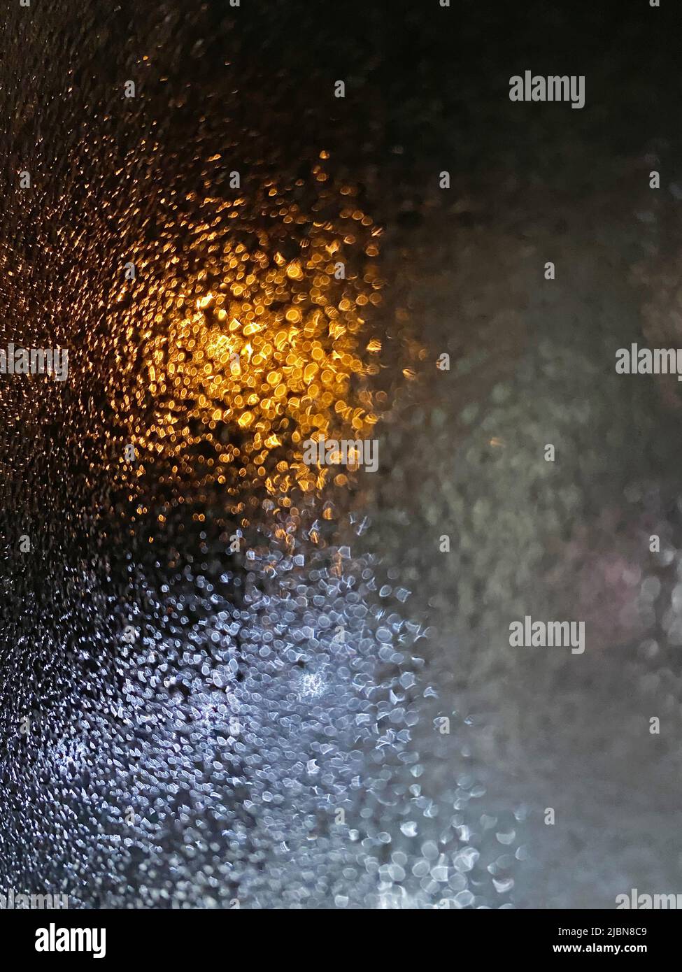 Photo of small rain splash drops on the windowpane, abstract images for backgrounds. Stock Photo