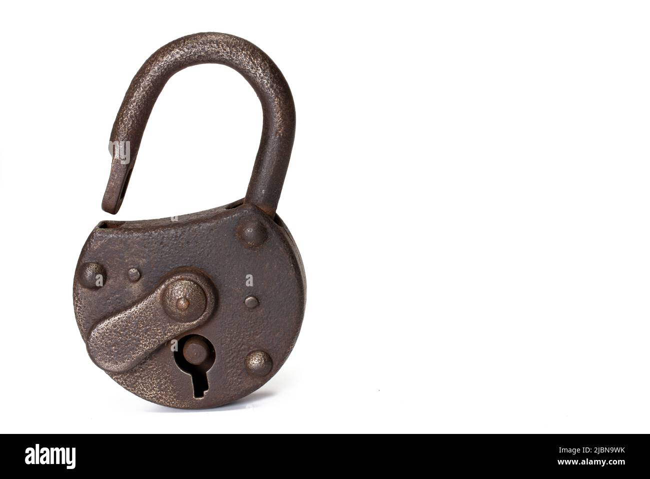 Old rusty shackle-lock standing on white background with open metal shackle and lock guard on white background Stock Photo