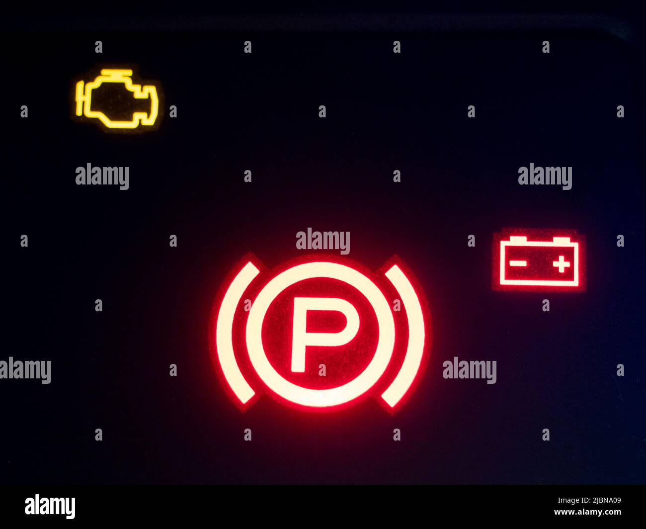 Red illuminated hand brake sign closeup Stock Photo Alamy
