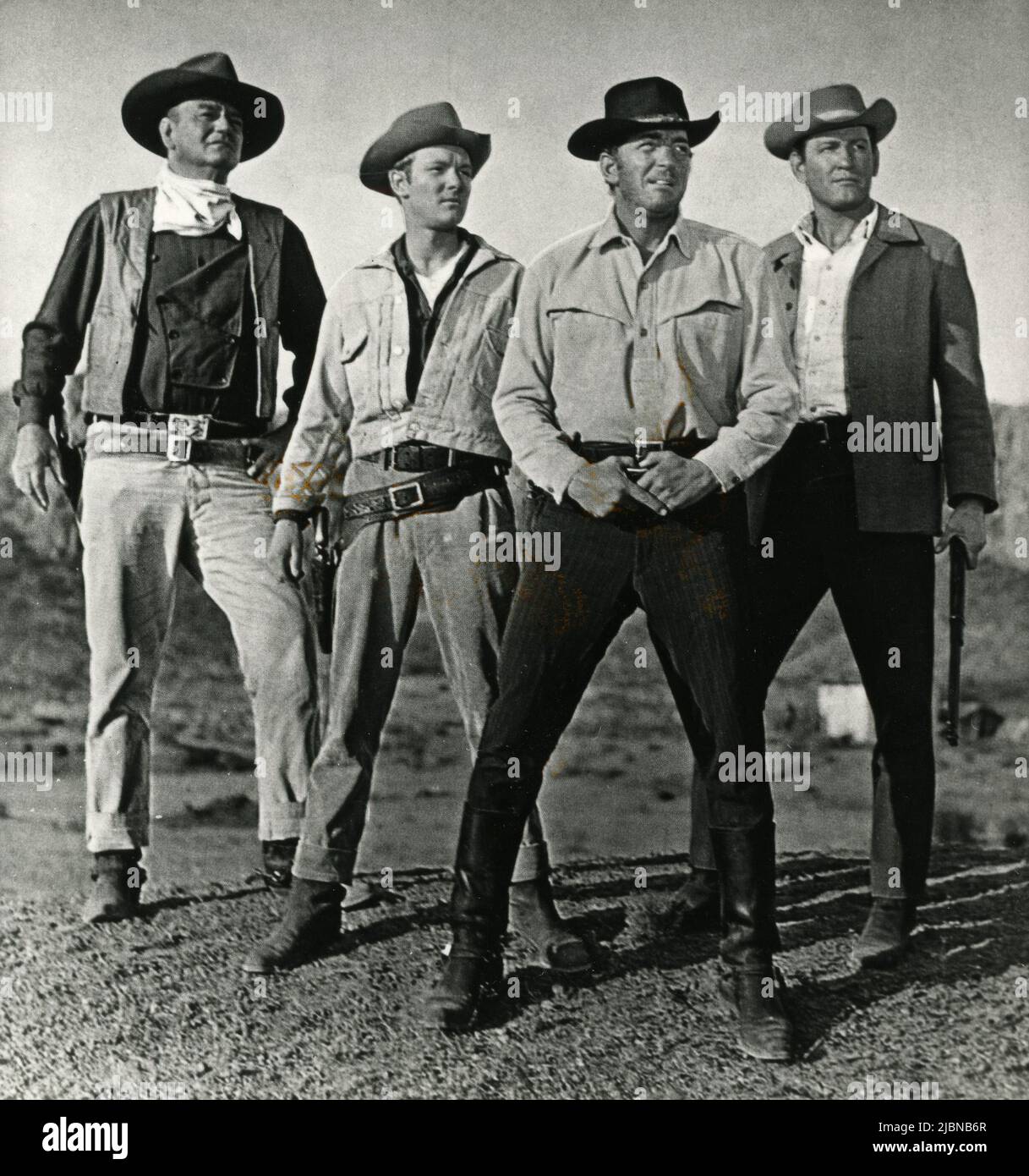 American actors John Wayne, Michael Anderson Jr., Dean Martin, and Earl Holliman in the movie The Sons of Katie Elder, USA 1965 Stock Photo