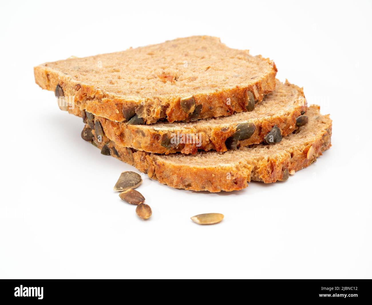 bread with pumpkin seeds on a white background. Pumpkin bread Stock