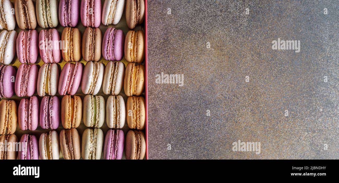 Cake french macaroons  in box on concrete background, top view with copy space Stock Photo