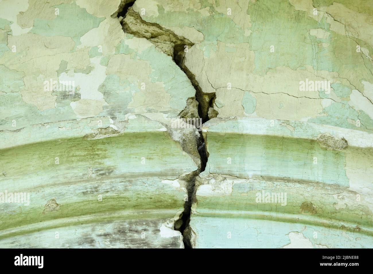 Big winding crack in arched structure, abstract image of vertical cleft. Close up. Copy space. Selective focus. Stock Photo