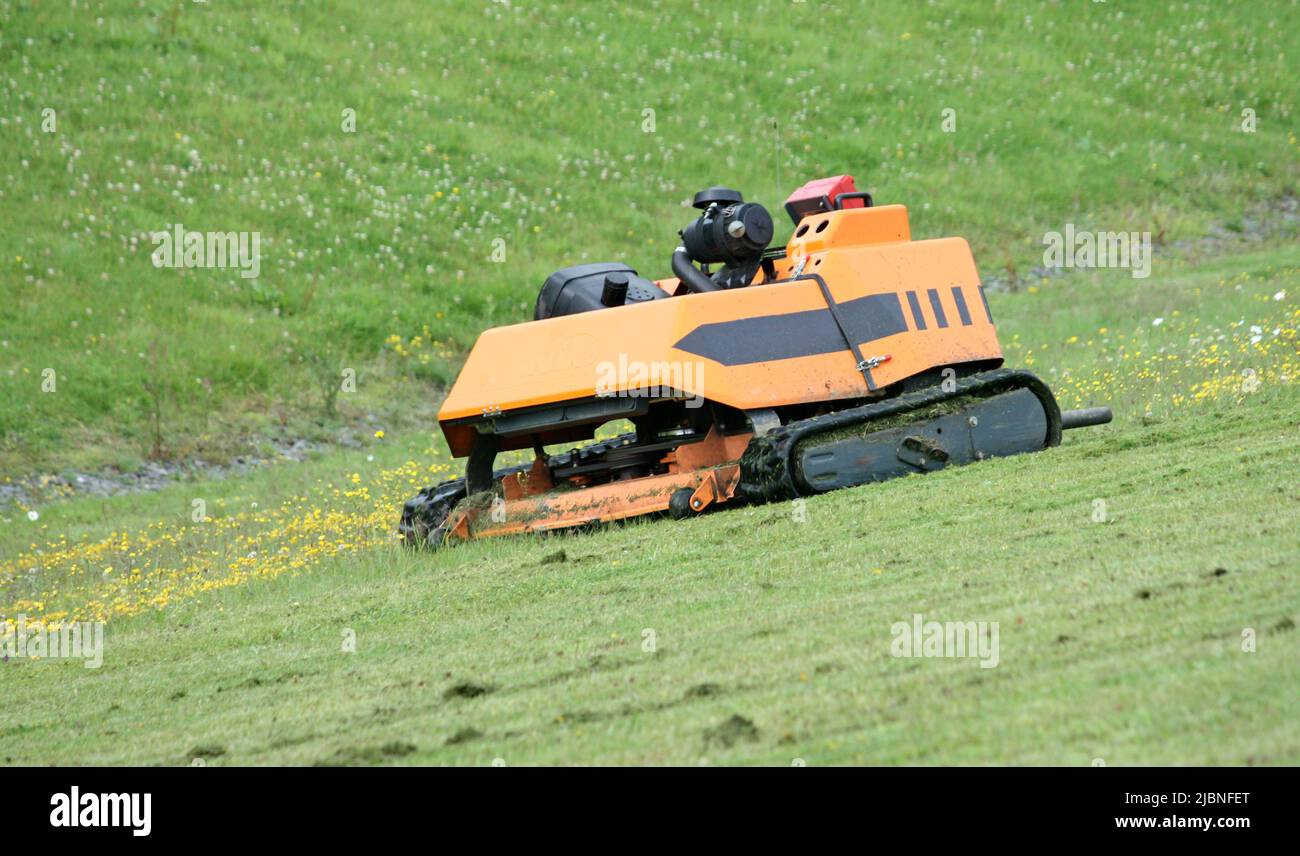 A Radio Controlled Grass Cutter on a Steep Bank Stock Photo Alamy