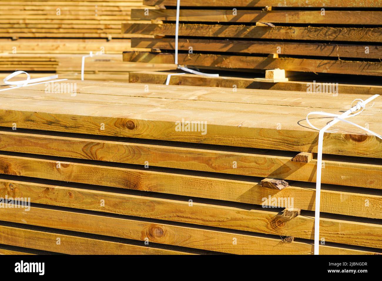 Stacked impregnated thick high quality pine wood boards for background and texture Stock Photo