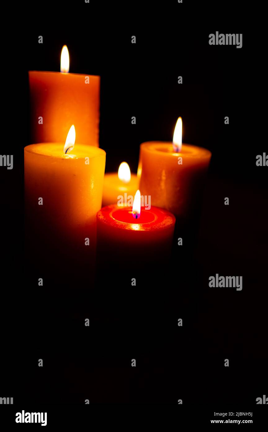 Burning red candles on black background copy space Stock Photo - Alamy