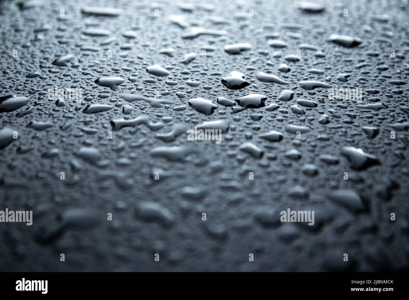 water spray droplets on black metallic surface Stock Photo - Alamy