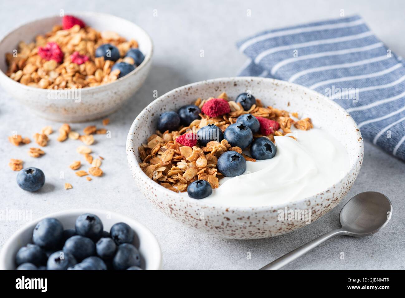 Yogurt bowl with granola and blueberries. Healthy breakfast or snack, rich in protein, fiber and calcium Stock Photo