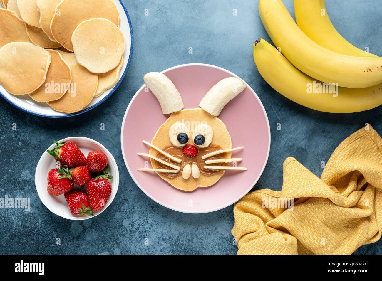 Funny breakfast kids pancake shaped as rabbit or bunny. Top view. Food art Stock Photo