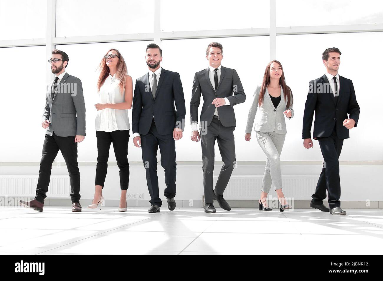 successful business team standing in the office hall Stock Photo - Alamy
