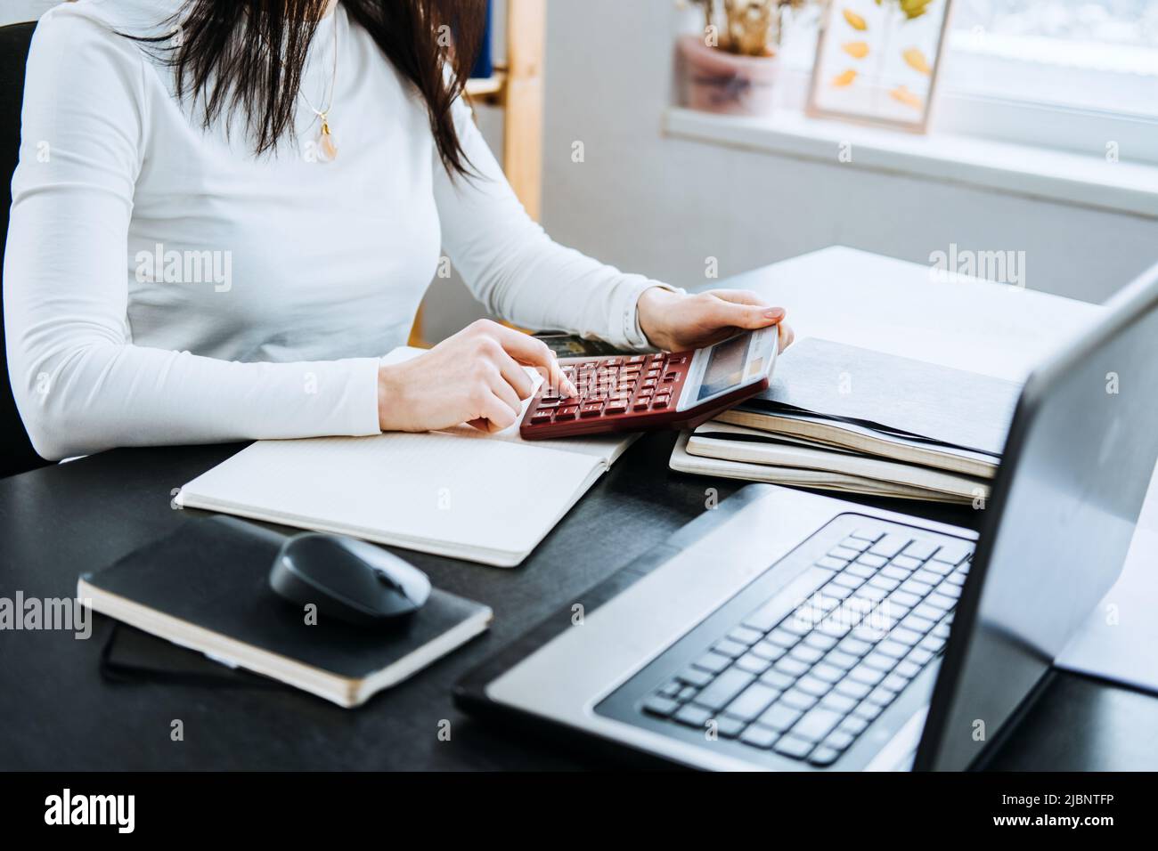 Account balance definition. Female Accountant working with laptop and