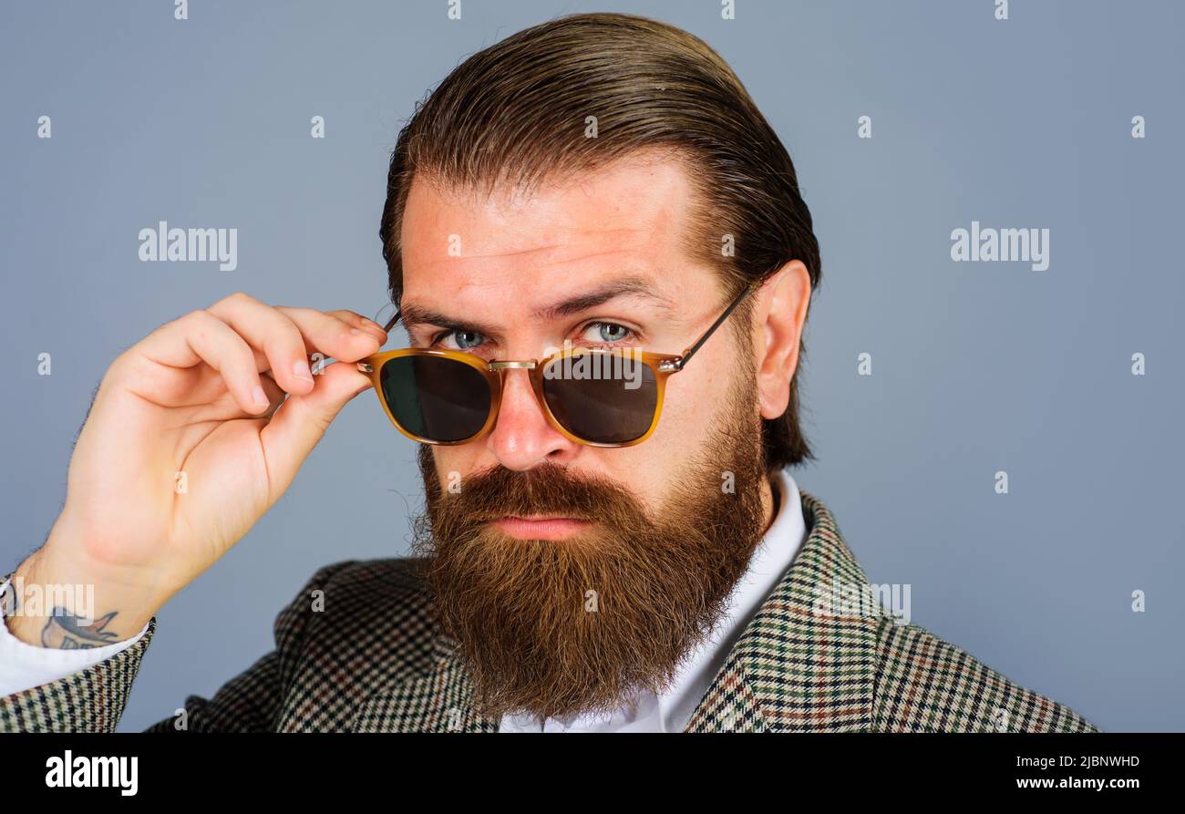 Handsome bearded businessman in sunglasses. Male fashion. Vogue. Eyewear advertising. Serious man. Stock Photo