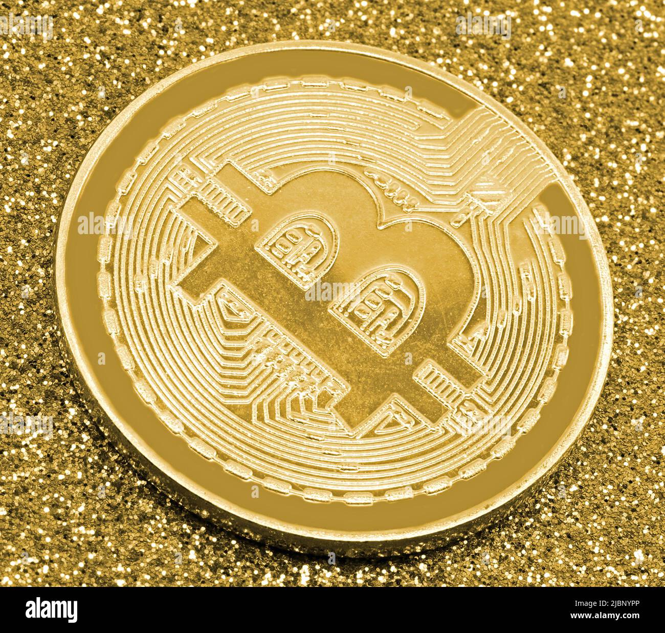 golden coin with the capital letter B which symbolizes the virtual  Cryptocurrency called BITCOIN most widespread in the world with the glitter  backgro Stock Photo - Alamy