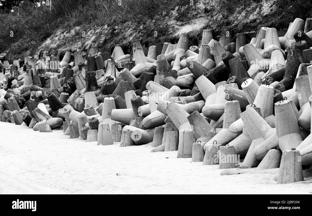 Concrete breakwaters made of tetrapod blocks. Breakwater on the beach