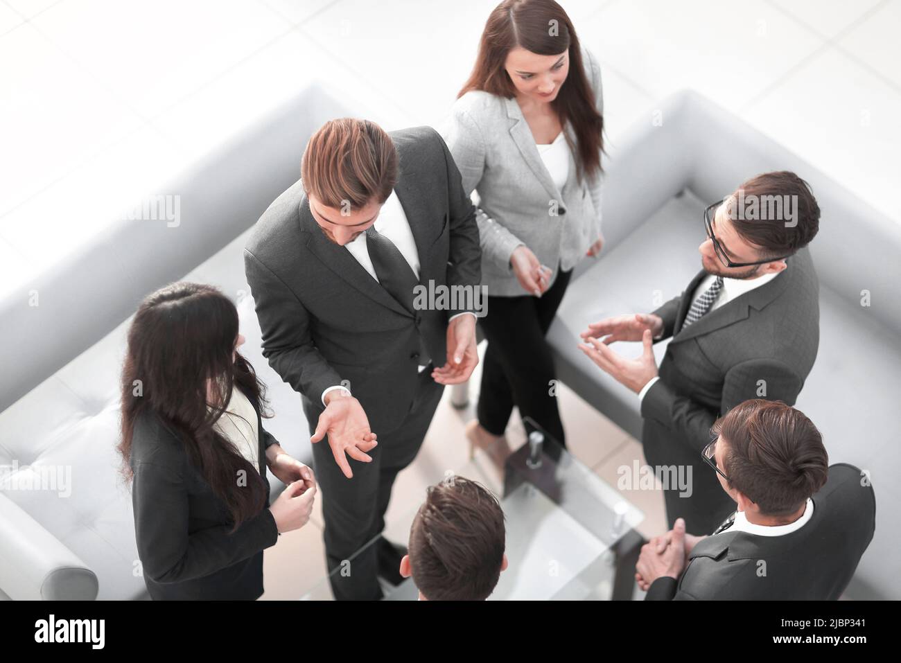 Happy smiling business team standing in a row at office Stock Photo - Alamy