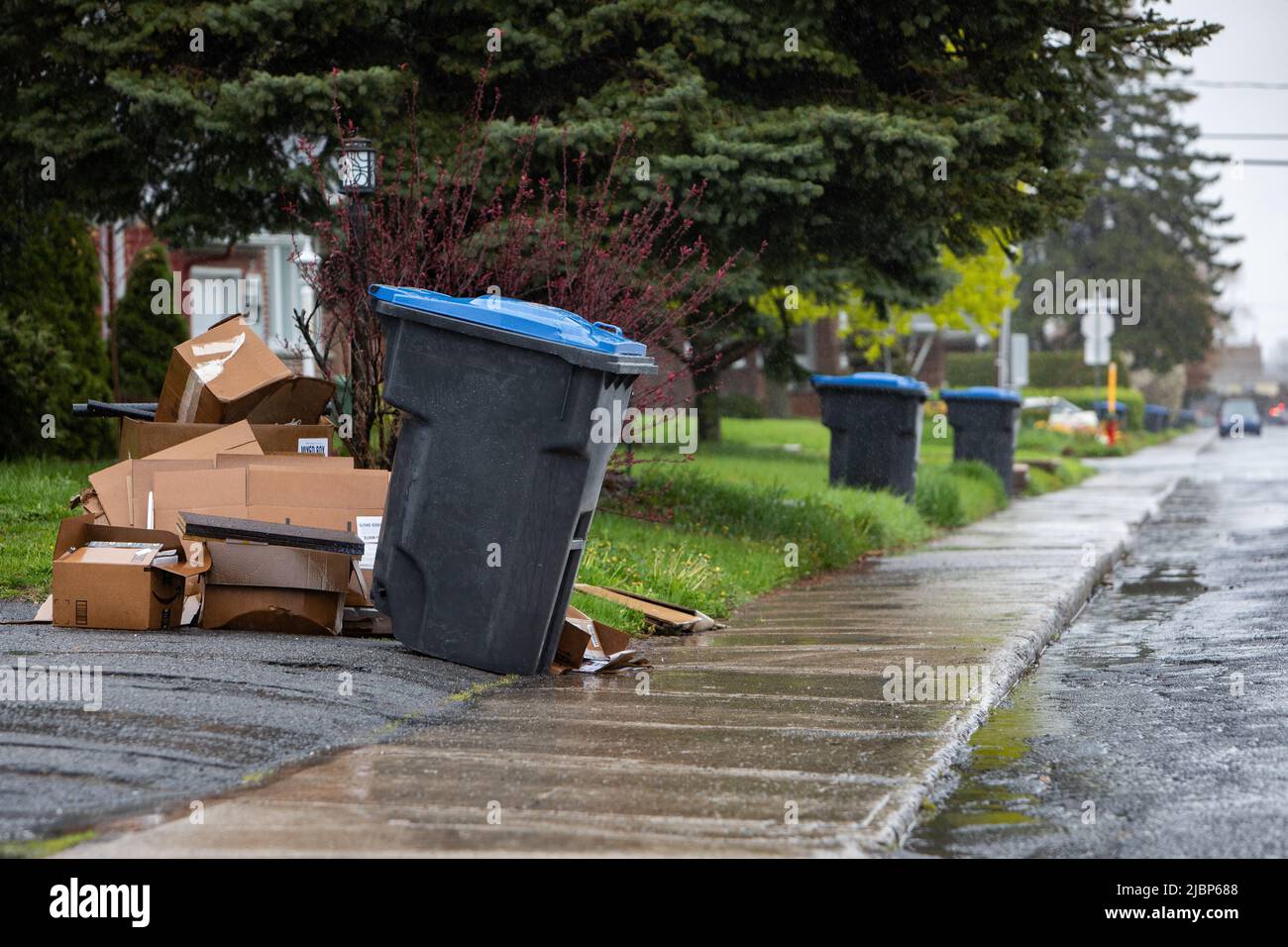 recycle bin on the street getting picked up by the recycle truck