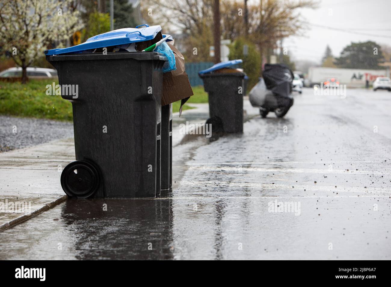 recycle bin on the street getting picked up by the recycle truck