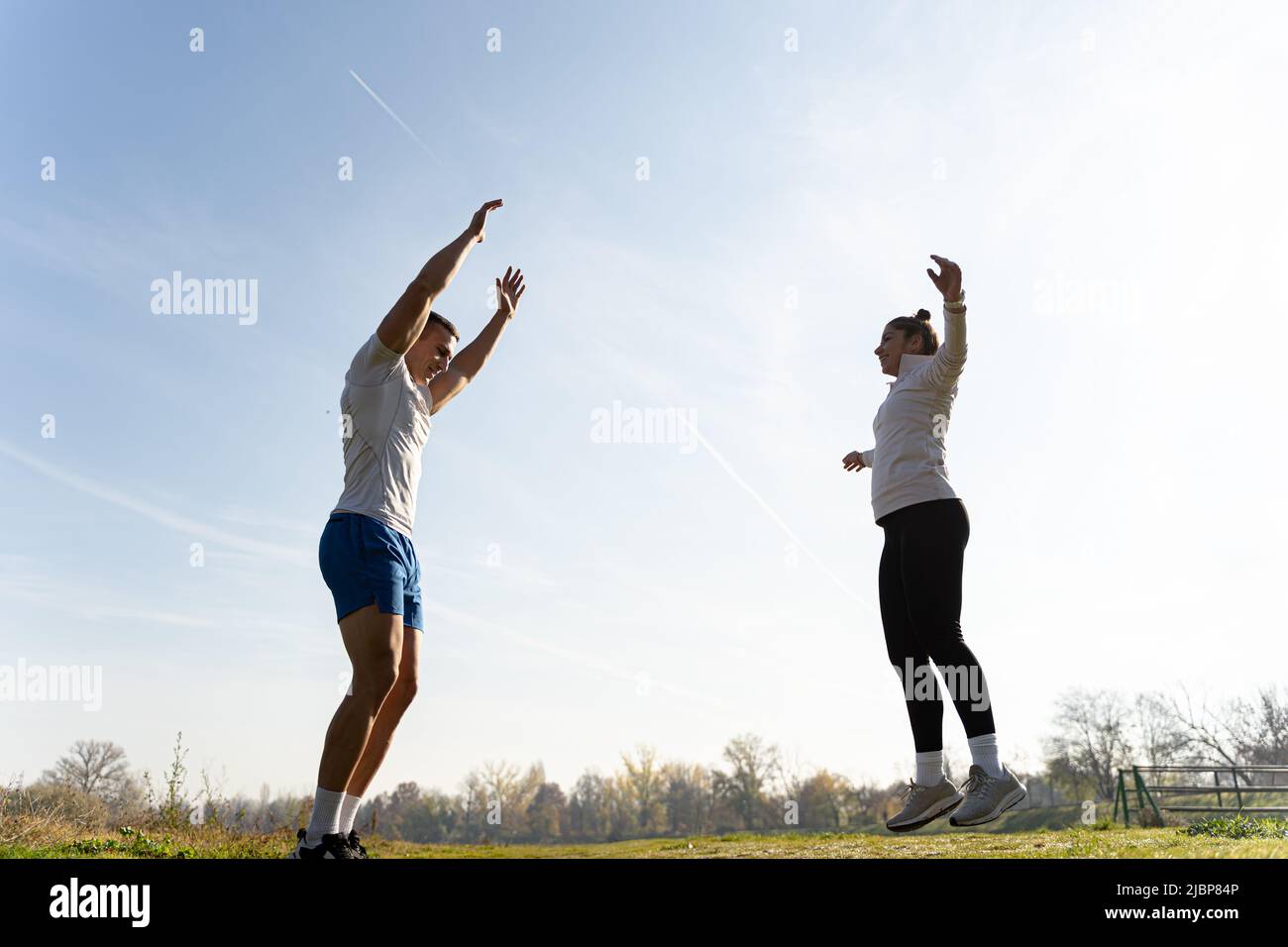 Two amazing and fit friends are doing a jumping jet exercise and