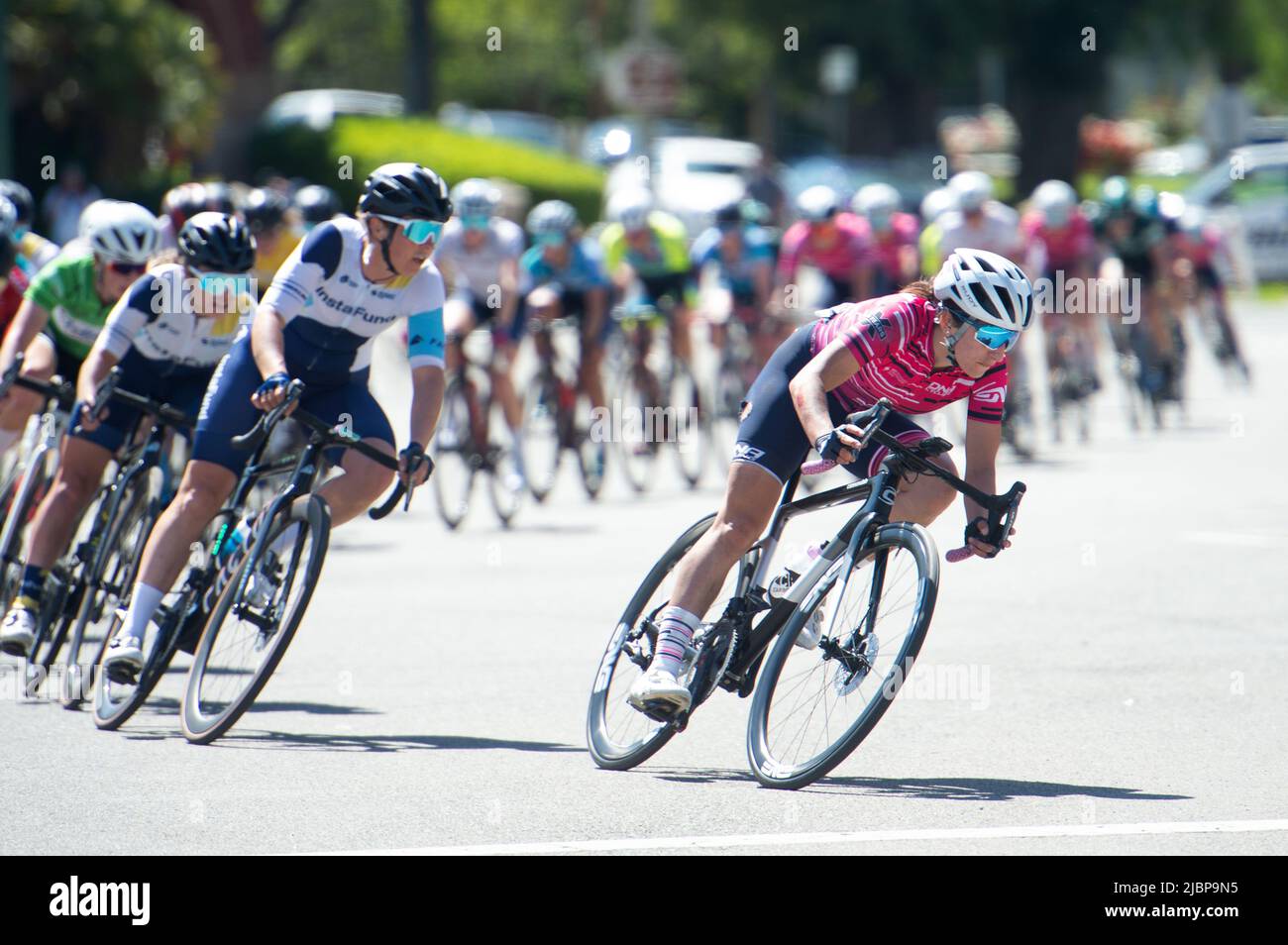 Women's peloton racing during the Redlands Classic Criterium in downtown Redlands, CA Stock Photo