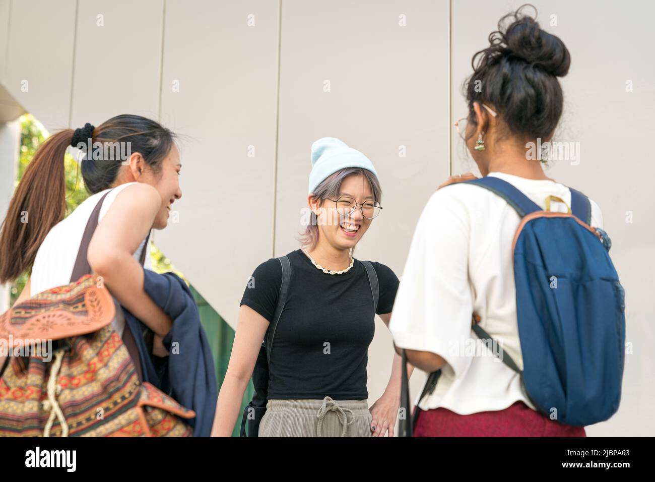 Group of young college multi-racial women students standing and laughing together. Stock Photo