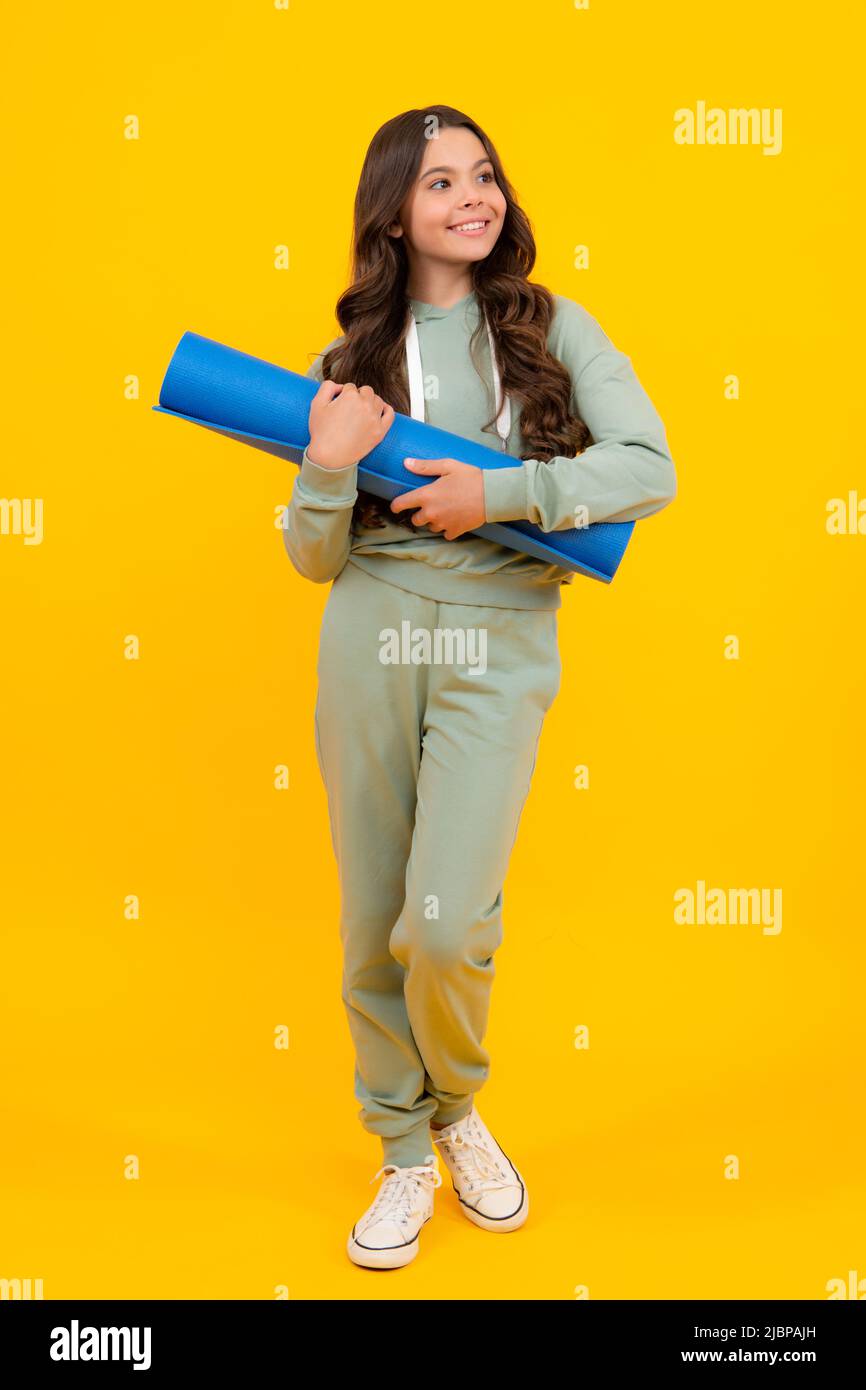 Teen girl 12, 13, 14 years old in sport suit. Fashion child in sportswear  sportive clothing. Sportive fashionable outfit. Studio shot on yellow Stock  Photo - Alamy