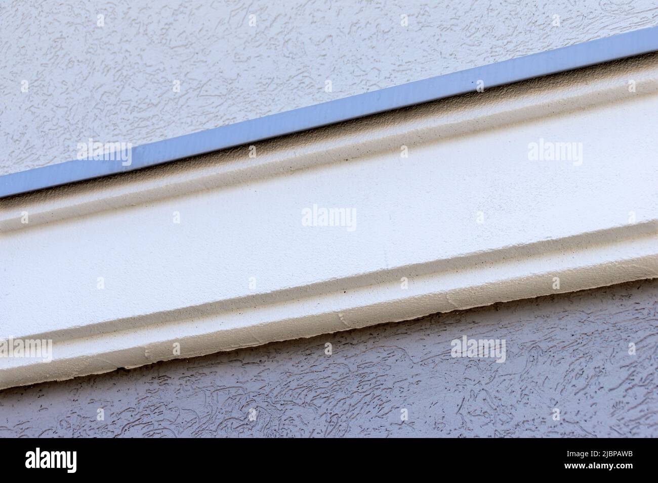 installation of a foam plastic building decor element for subsequent painting or plastering, selective focus Stock Photo