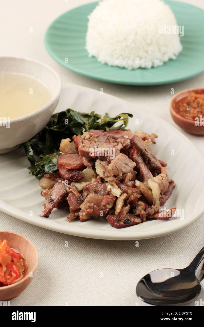 Beef Sei Sapi, Indonesia Traditional Smoked Beef, Served with Boiled Cassava Leaves and Sambal Luat or Sambal Matah. Typically Food from Nusa Tenggara Stock Photo