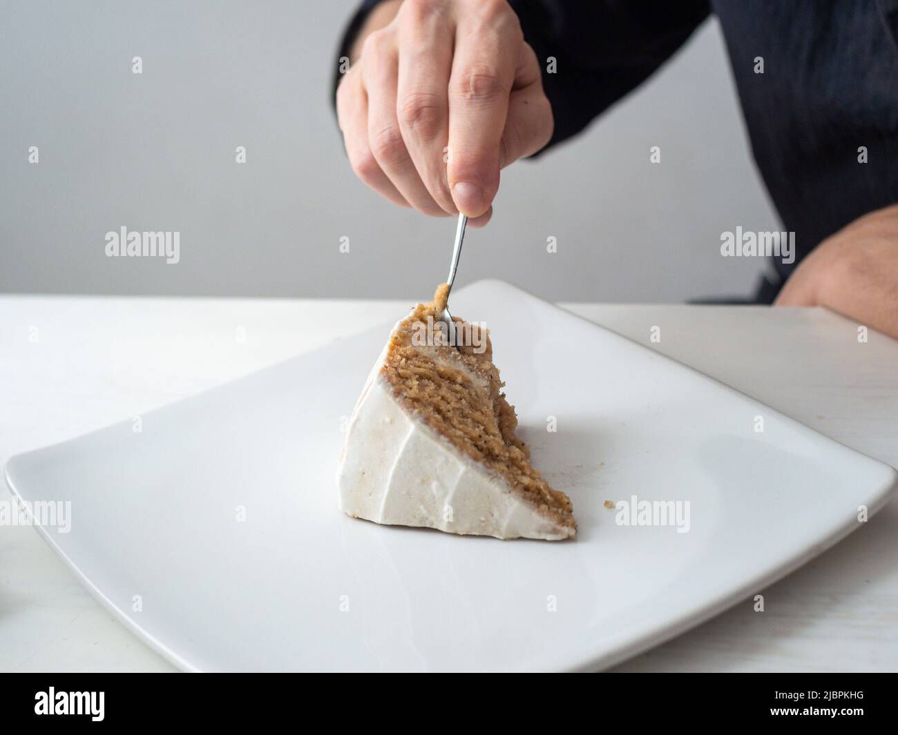 Lemon Base A Man's Hand Cuts a Piece of Vegan Lemon Layer Cake with Almond ...