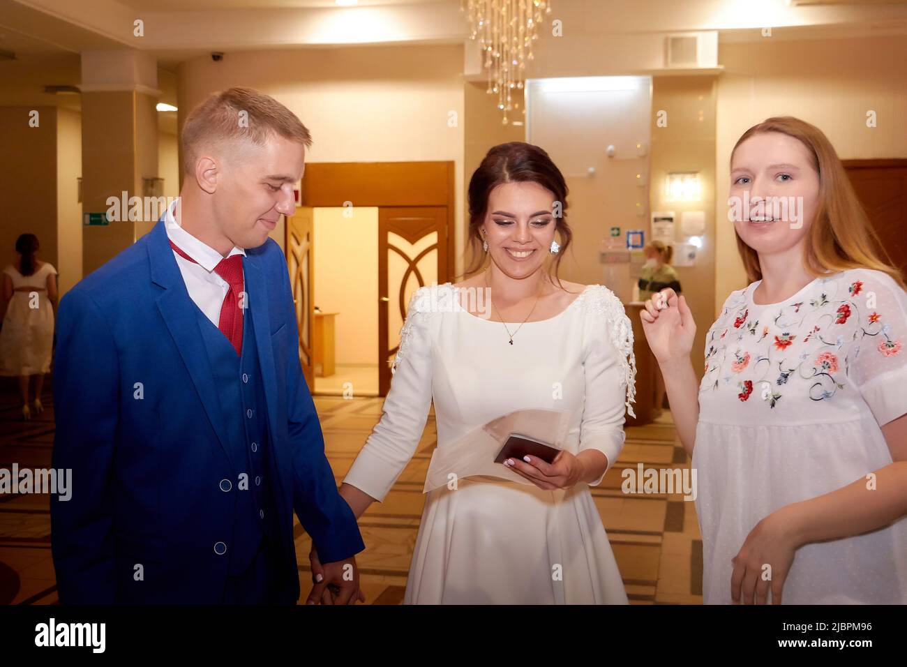 Kirov, RUSSIA - August 10, 2021: The bride and groom at the registry office after the official marriage ceremony and people, friends, relatives Stock Photo