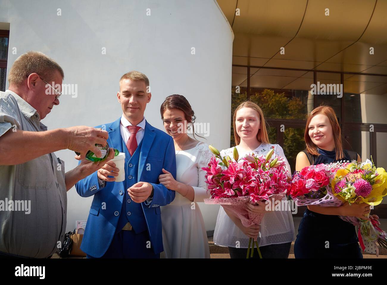 Kirov, RUSSIA - August 10, 2021: The bride and groom at the registry office after the official marriage ceremony and people, friends, relatives Stock Photo