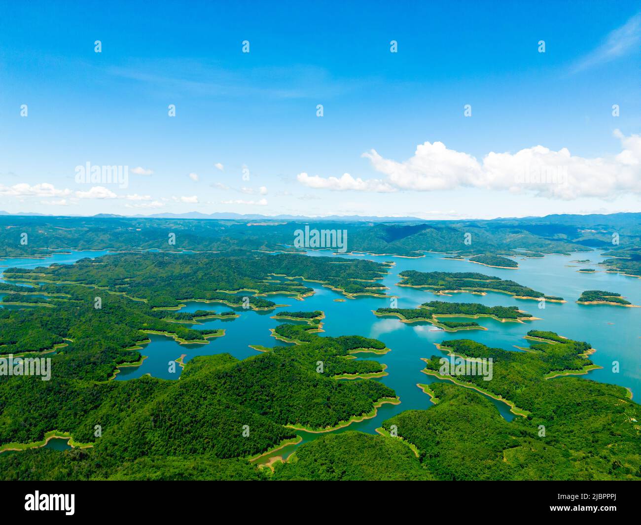 Morning at the Ta Dung lake or Dong Nai 3 lake with green hills and mountains. The reservoir for power generation by hydropower in Dac Nong ( Dak Nong Stock Photo