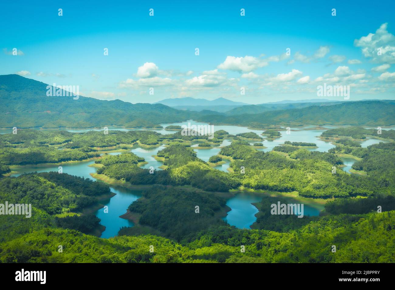 Morning at the Ta Dung lake or Dong Nai 3 lake with green hills and mountains. The reservoir for power generation by hydropower in Dac Nong ( Dak Nong Stock Photo