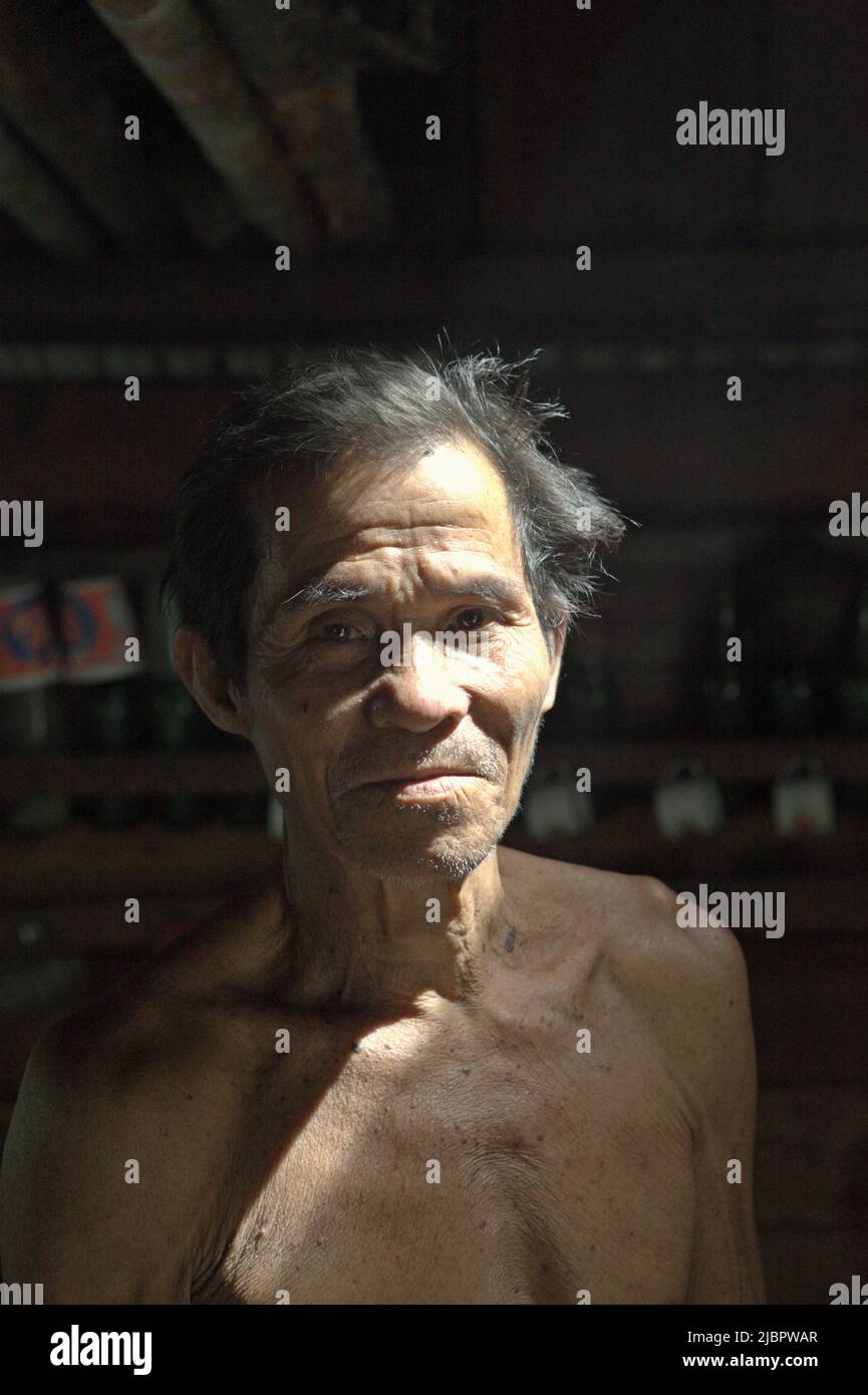 Portrait of Daniel Rajang, former tumenggung (traditional chief) of Orung Da'an Dayak community, at his farming hut in Nanga Raun village, Kalis, Kapuas Hulu, West Kalimantan, Indonesia. The Orung Da'an community once had the longest longhouse in Kalimantan, but it was vanished after a fire accident a few decades back, he said. Stock Photo