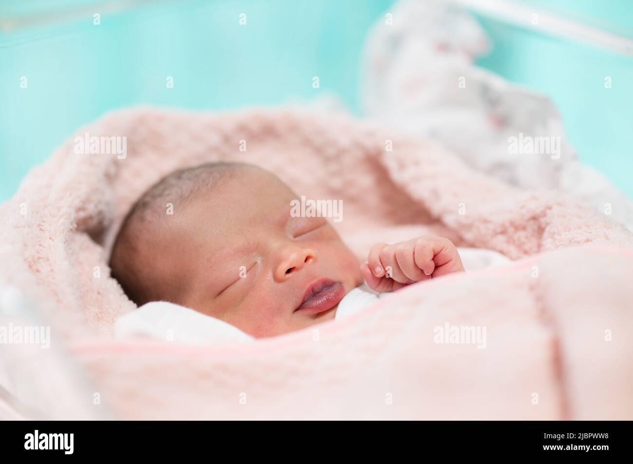 newborn baby face closeup Sleeping in table in hospital Stock Photo