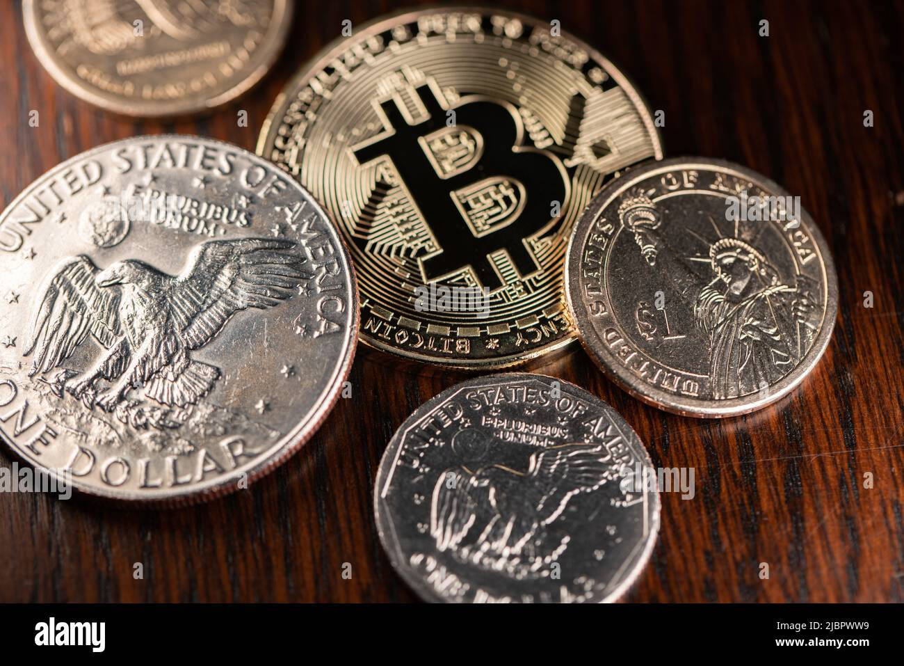 One Dollar coin next to a Bitcoin on Wooden Background. Crypto currency  concept. Digital Money working on Blockchain technology. United States  Dollar Stock Photo - Alamy