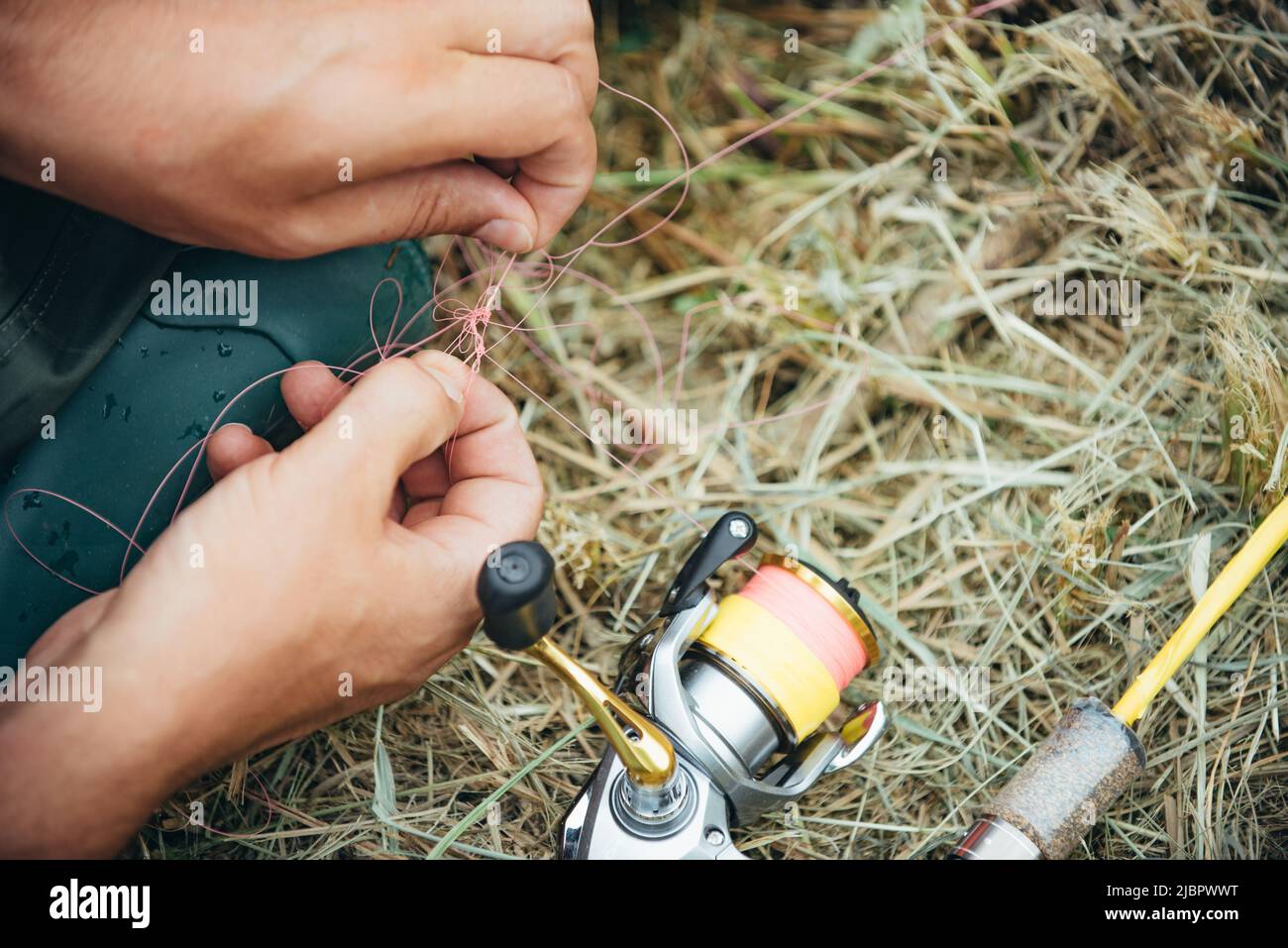 Man hand with rod, spinning reel close up Stock Photo - Alamy