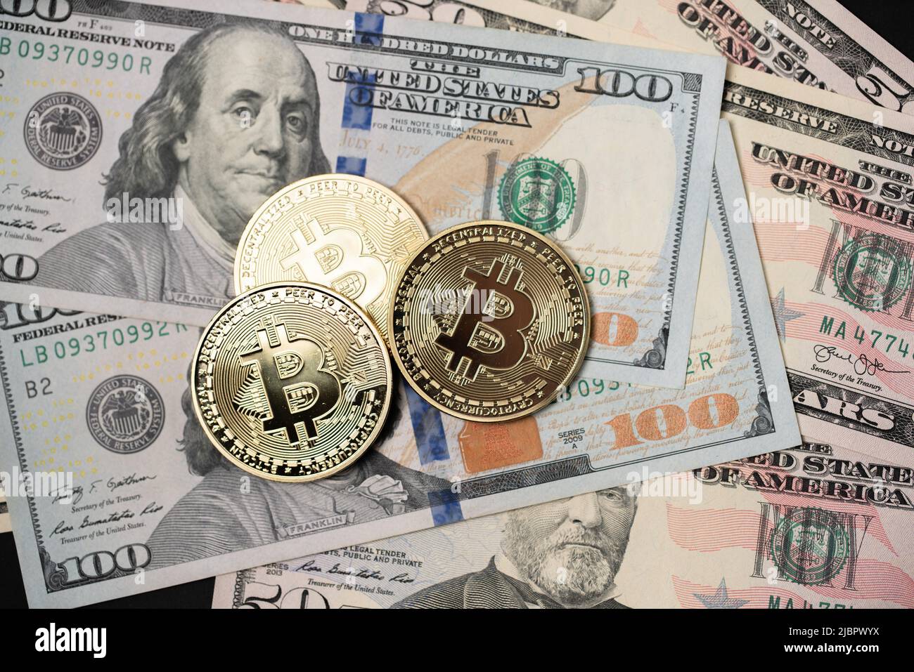 Metal shiny bitcoin crypto currency coins on US dollar bills