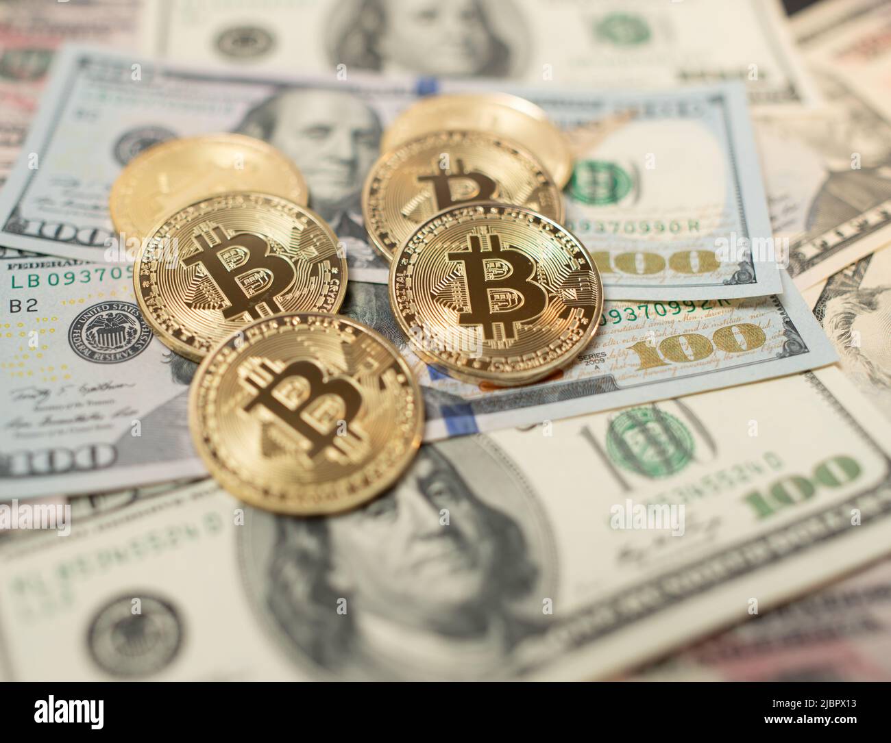 Bitcoin coin on one hundred dollar banknotes from united states of america.  Digital crypto currency and US dollar currency. Gold shining coins on pile  Stock Photo - Alamy