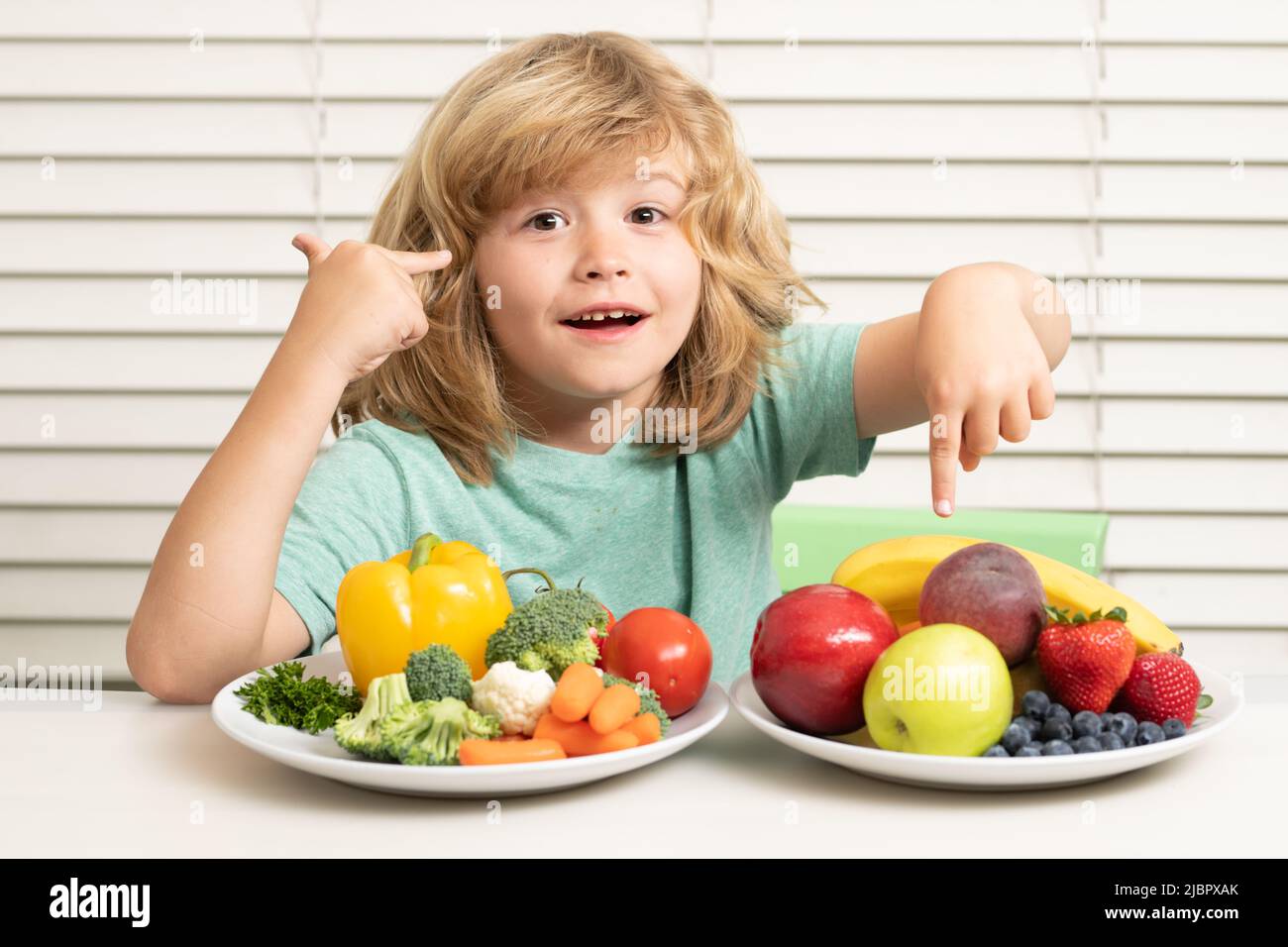 Fruits and vegetables. Child eats organic food. Healthy vegetables with
