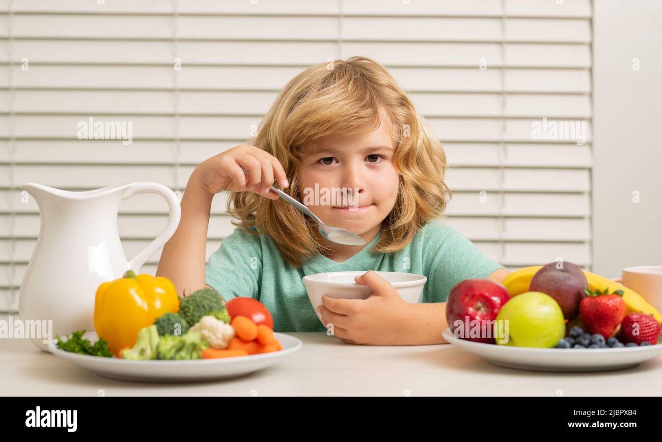 Little child boy having healthy breakfast. Kids nutrition and development. Eating vegetables by child make them healthier. Stock Photo