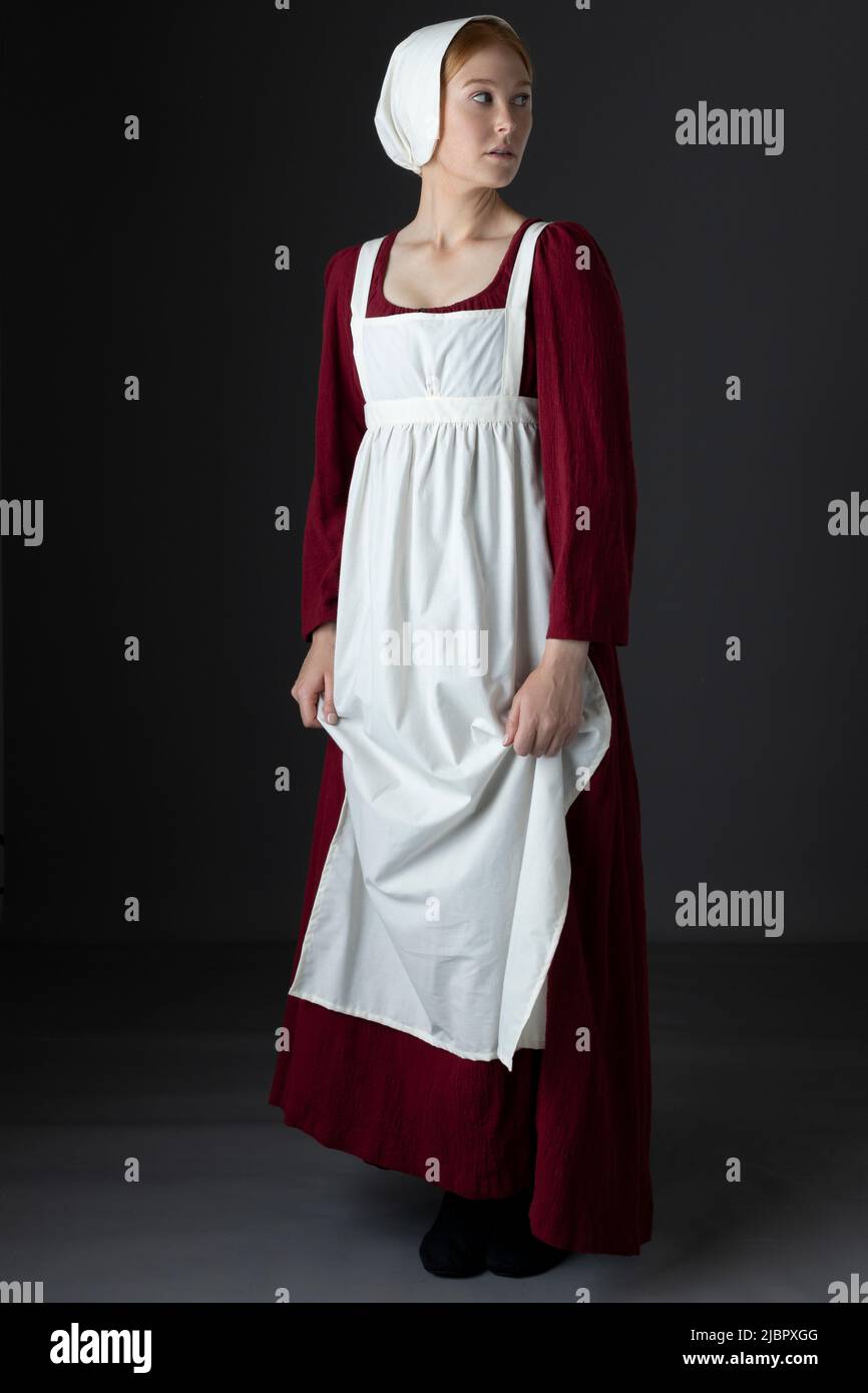 A Regency serving maid wearing a red dress and an apron Stock Photo Alamy