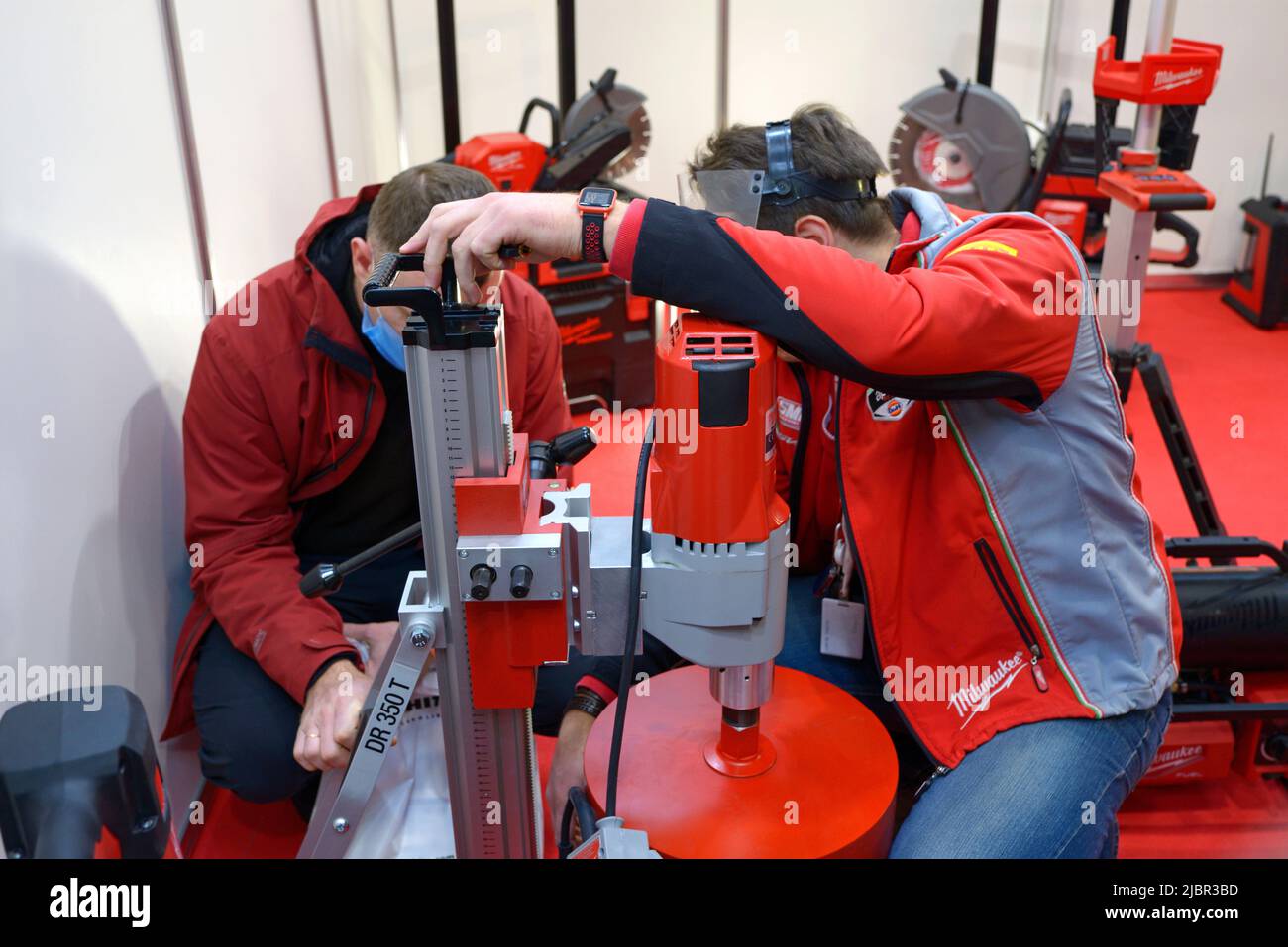 Managers set diamond drilling rig Milwaukee on stand. ClimaFest 2021