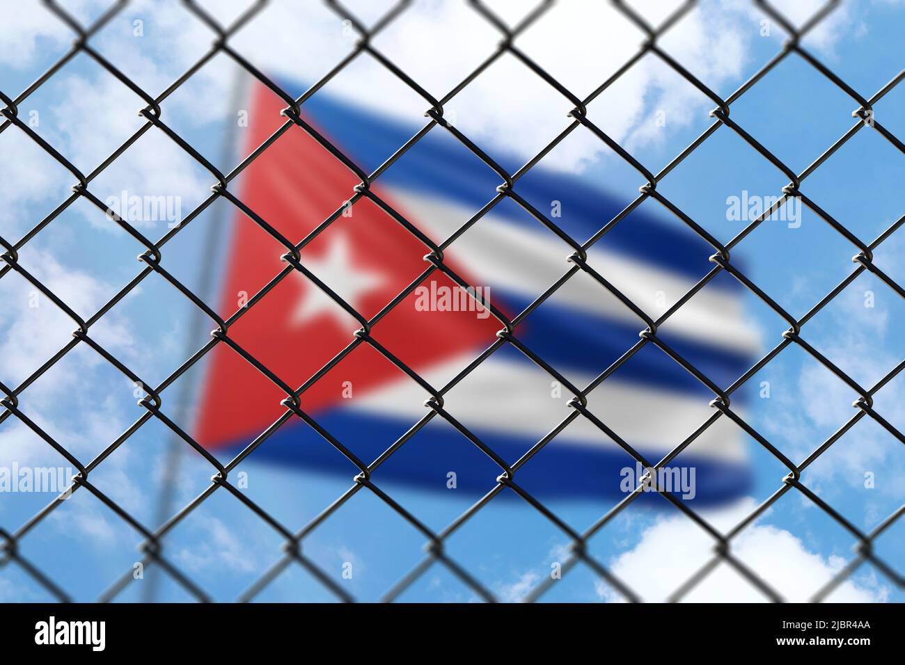 A steel mesh against the background of a blue sky and a flagpole with the flag of cuba Stock Photo