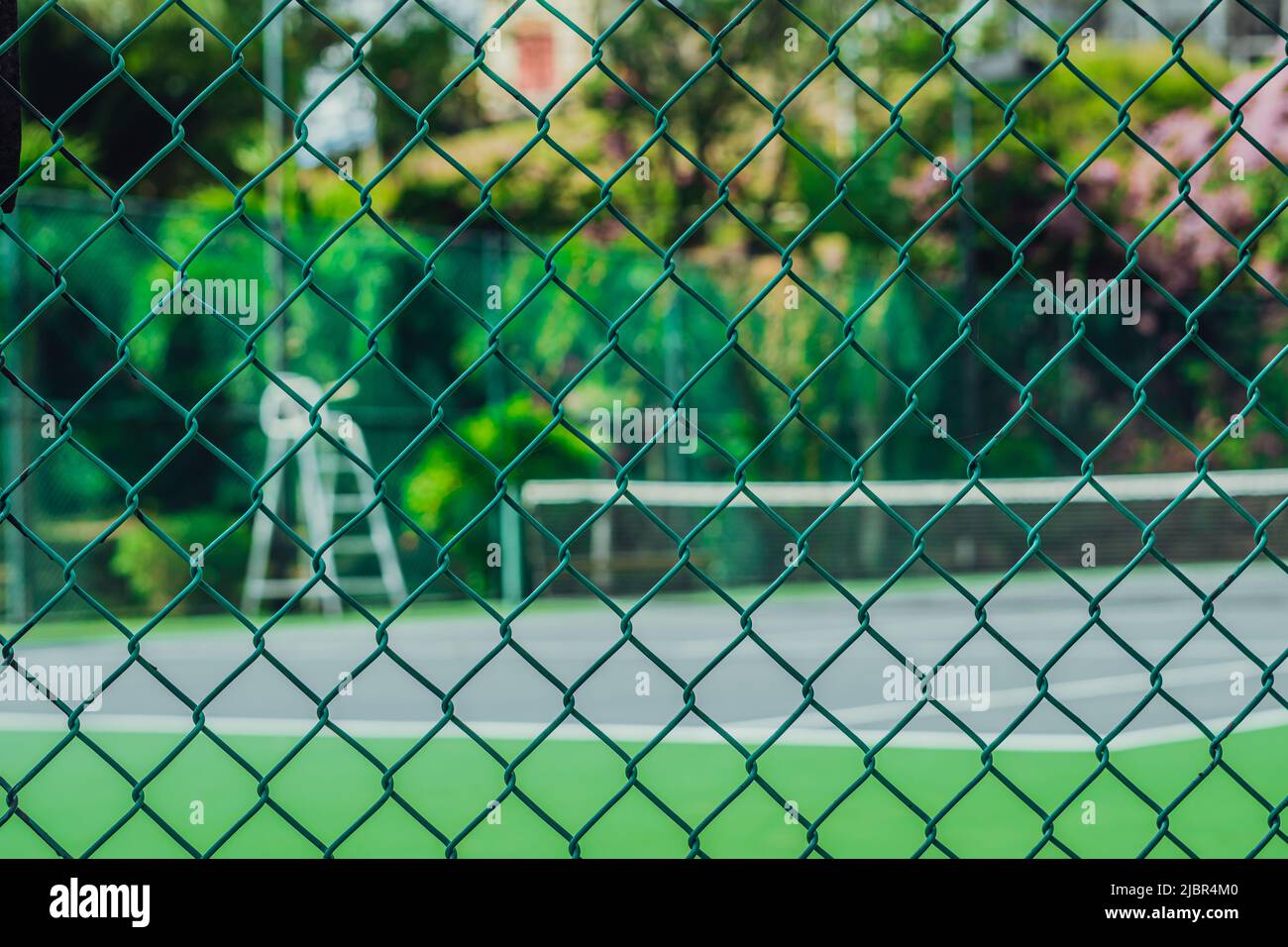 Empty tennis court in modern fashion hotel, tower for referee, view