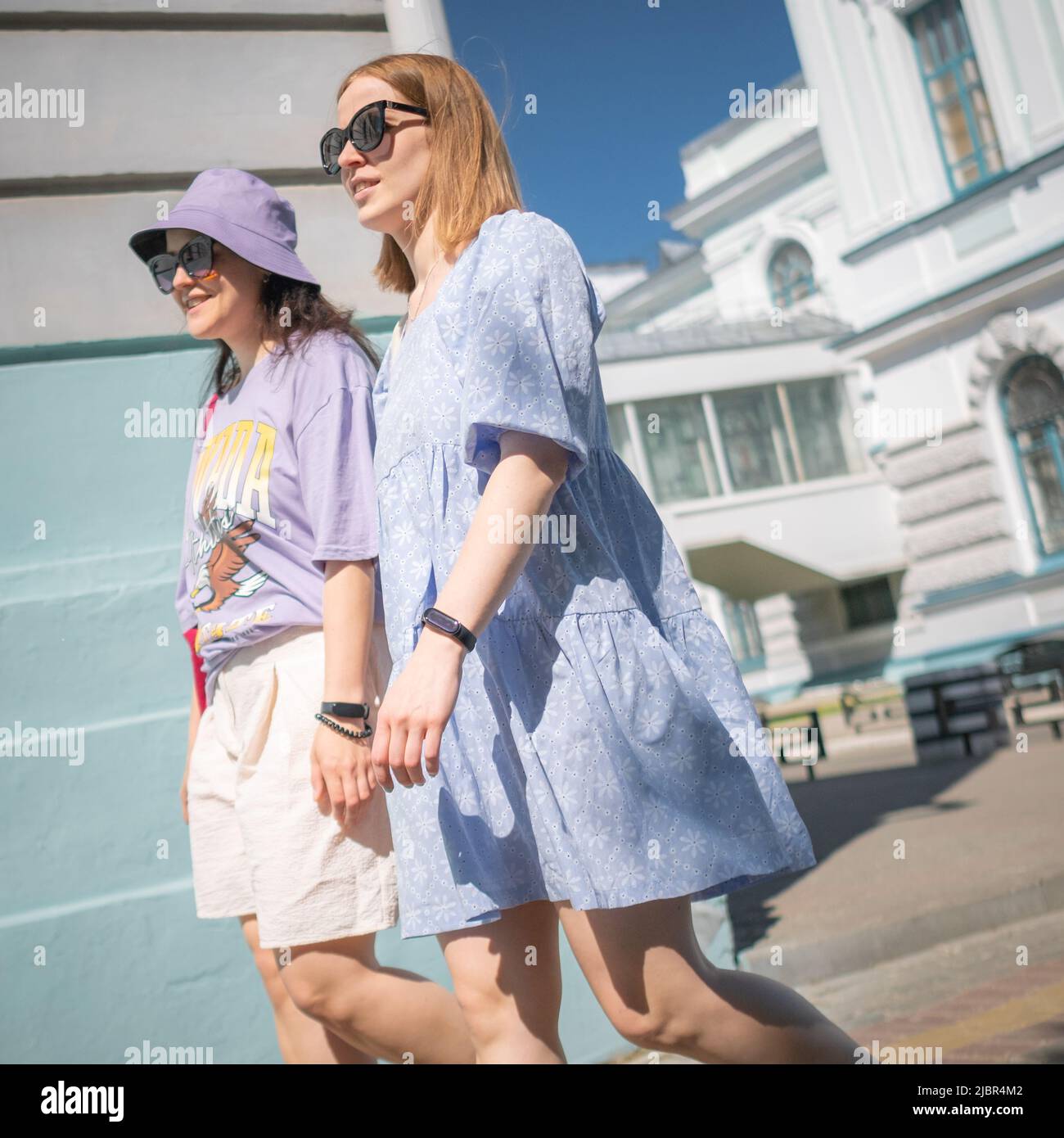 25 th of May, Russia, Tomsk, two girls walk on street in summer editorial Stock Photo