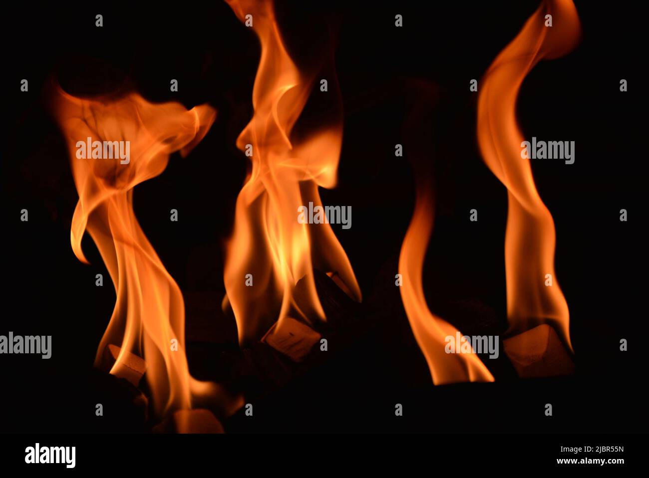 Flames flickering in the dark - golden colour Stock Photo
