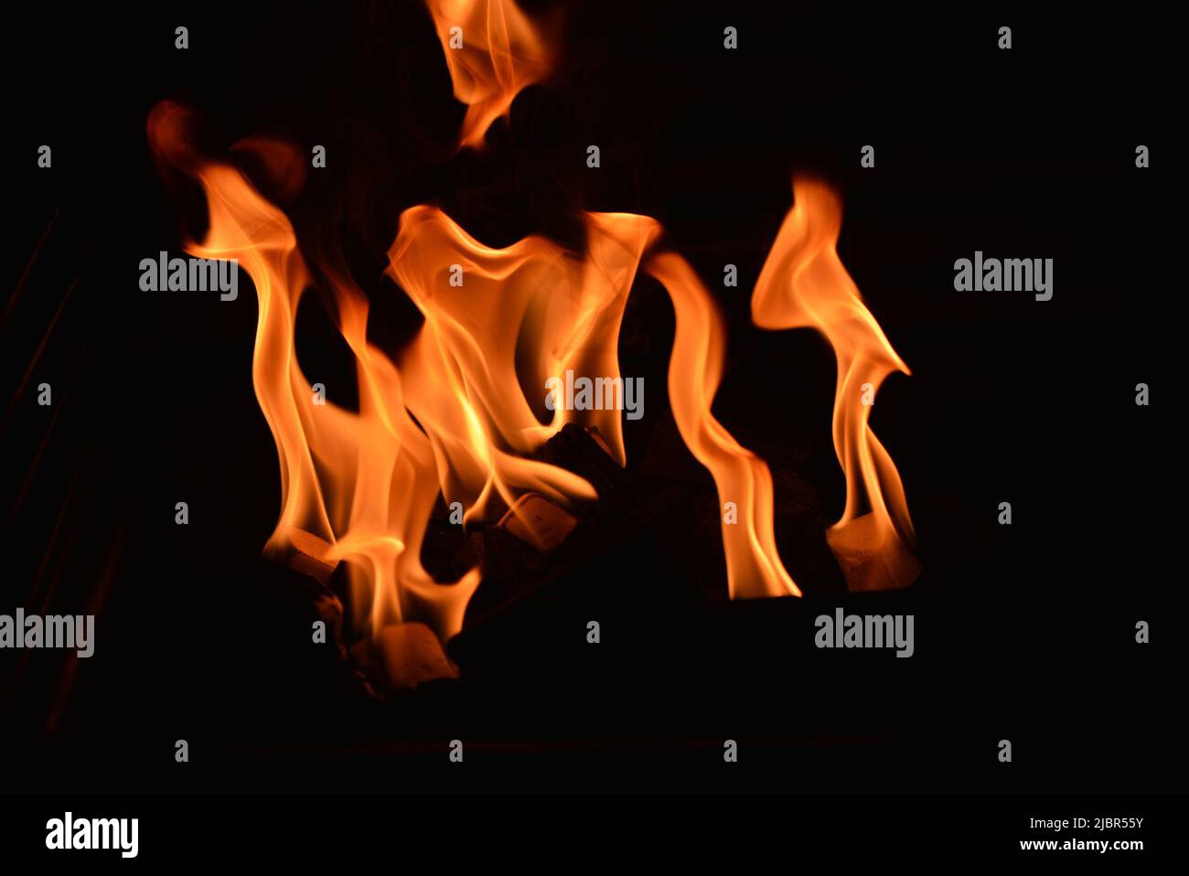 Flames flickering in the dark - golden colour Stock Photo - Alamy